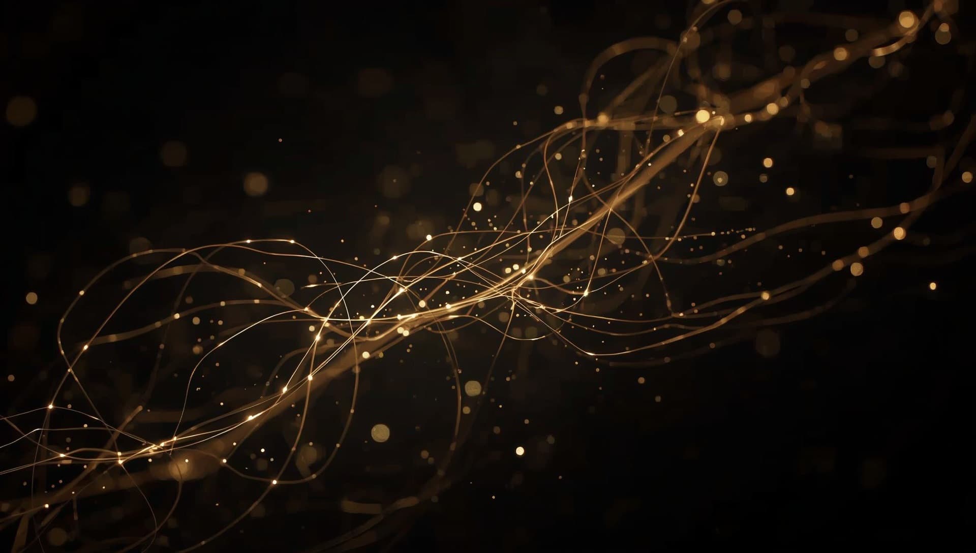 Abstract golden threads of light weaving through darkness